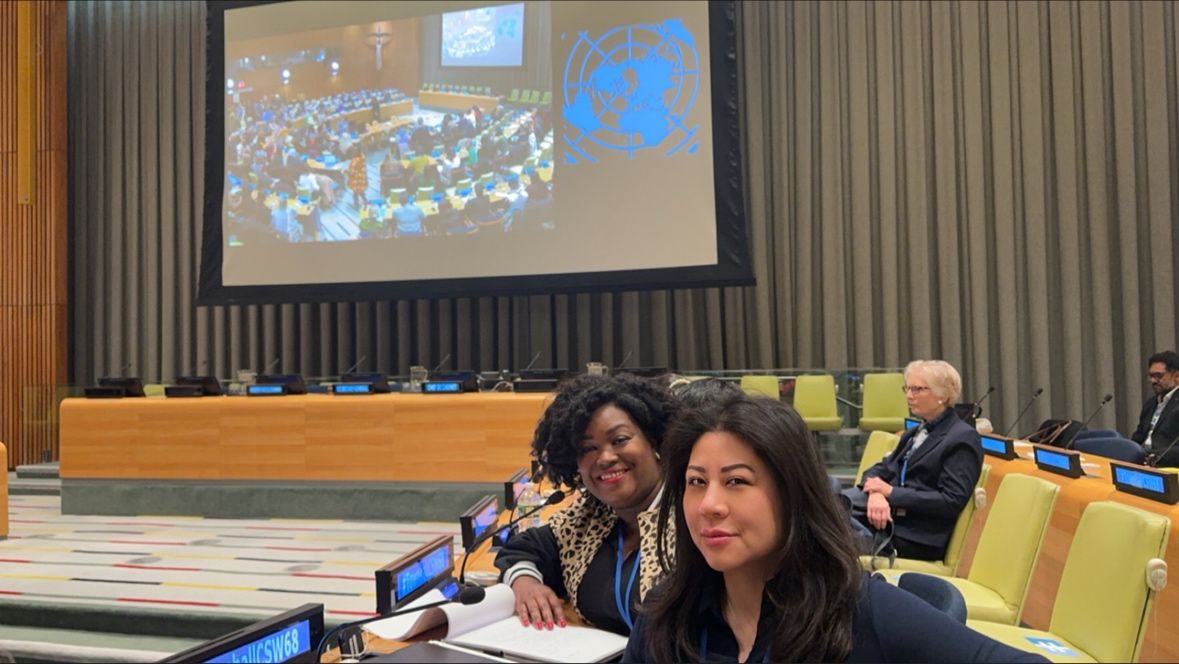 Two women from Single SuperMom organisation sitting inside a UN conference room.