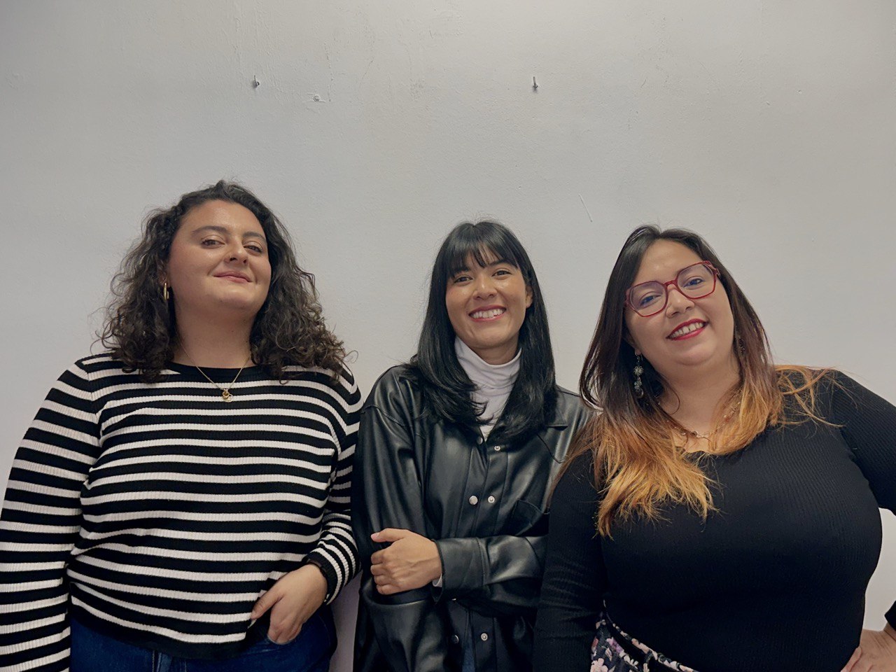 Three women smiling at the camera