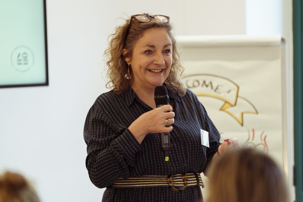 Woman speaking at the AGE event