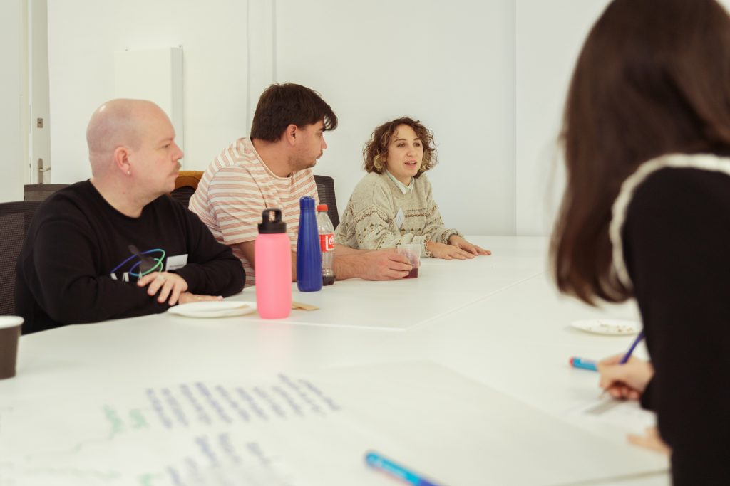 4 or 5 people talking at the boardroom