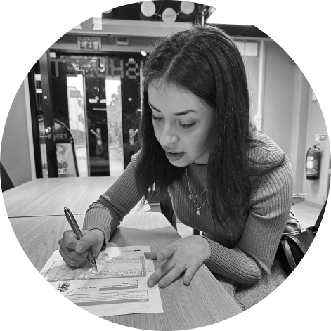 Woman taking notes on a sheet of paper. Photo in black and white.