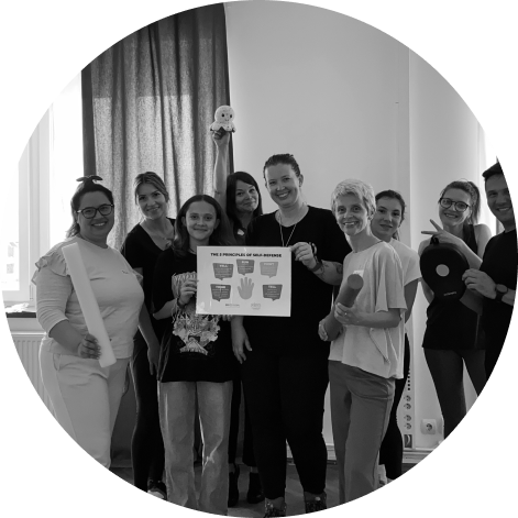 Group of people smiling at the camera while carrying a poster. Photo in black and white.