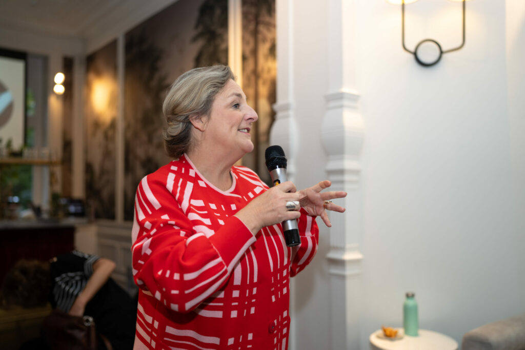 A facilitator speaks into a microphone.