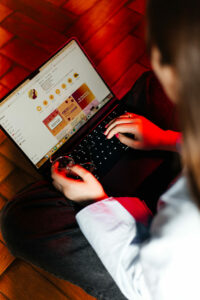 Woman typing on a laptop seen from above